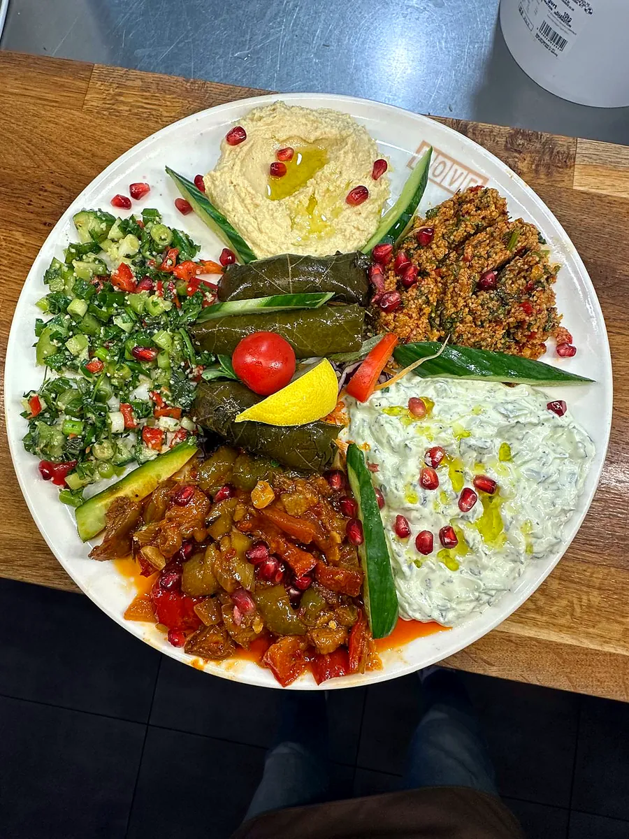 Cold meze sharer with houmous, kisir, tabuleh, dolma, cacik and saksuka, topped with pomegranate
