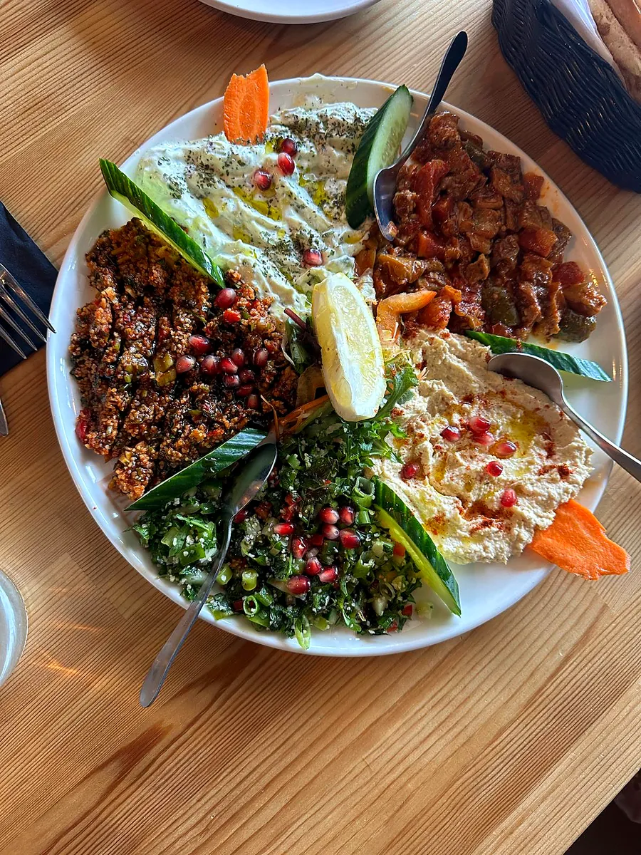 Meze plate with kisir, tabuleh, houmous and pomegranate