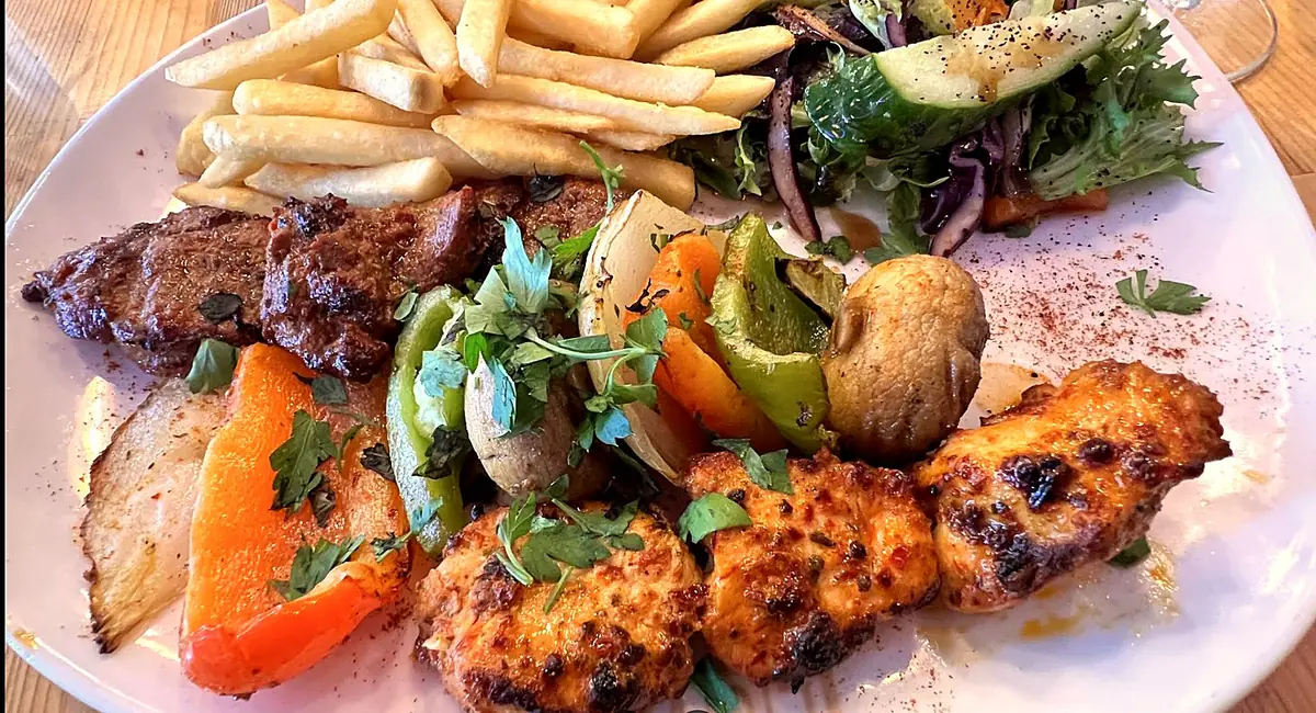 Turkish mixed grill at Love Dulwich with lamb, chicken shish, grilled peppers, mushrooms, chips and salad